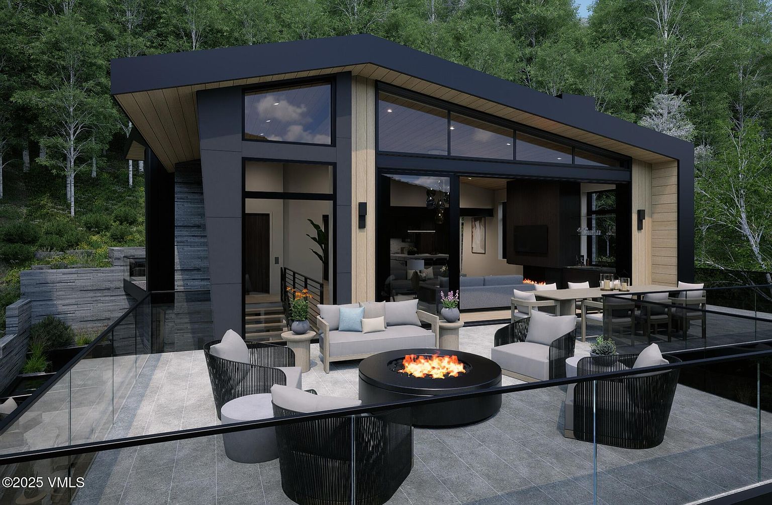 This image showcases a modern home's outdoor living space, featuring a spacious patio with a fire pit surrounded by comfortable seating. The patio is furnished with stylish chairs and a sofa, creating an inviting atmosphere for relaxation and entertainment. A dining table with chairs is also visible, suggesting an area for outdoor meals, all set against a backdrop of lush greenery.