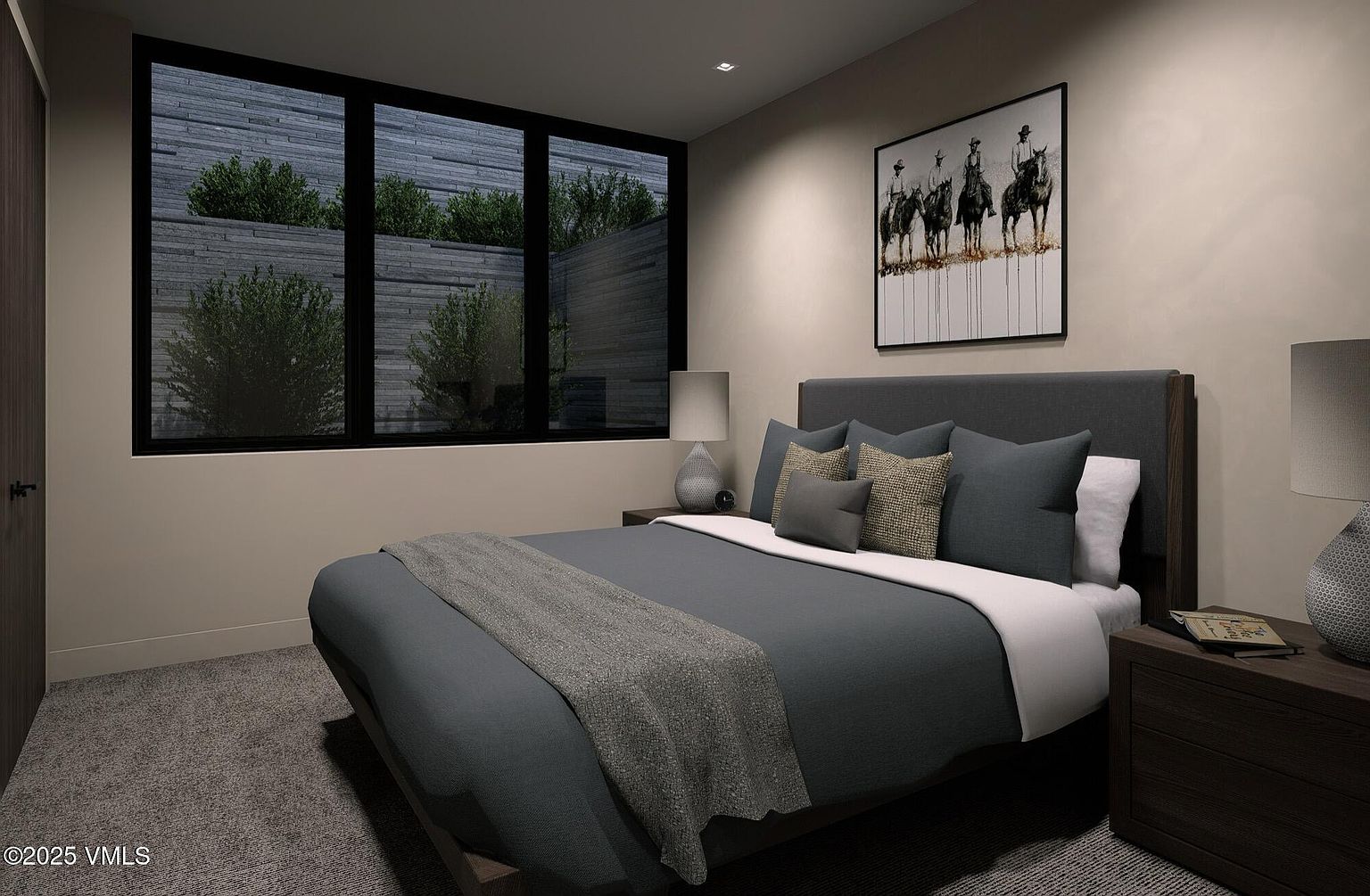This is a primary bedroom featuring a large bed with a gray headboard and blue bedding. A piece of art hangs above the bed, and there are two nightstands with lamps on either side. The room has a modern aesthetic with a large window providing natural light and a view of greenery outside.