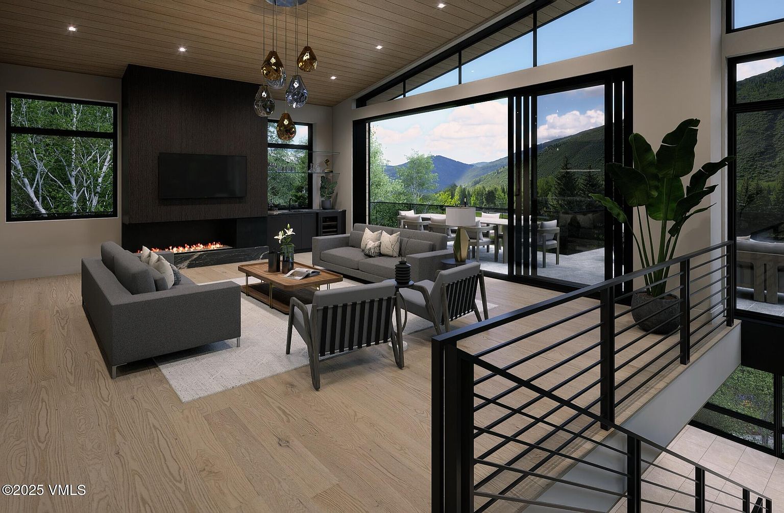 This is a modern living room featuring a fireplace, a flat-screen TV, and comfortable seating. Large windows offer stunning views of the mountains. The room is decorated in neutral tones, creating a relaxing and inviting atmosphere, perfect for a luxury home.