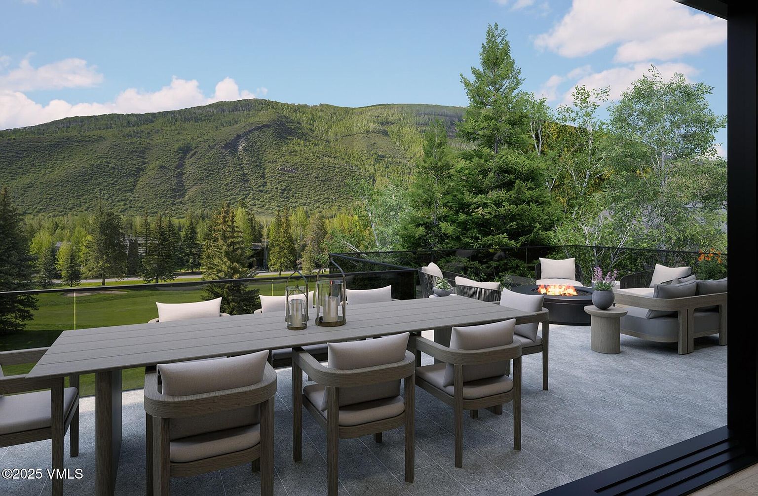 This image showcases a luxurious outdoor patio or deck area, featuring a large dining table with comfortable seating, a cozy fire pit with lounge chairs, and a stunning mountain view. The space is designed for relaxation and entertainment, with a modern aesthetic and high-end finishes. The patio is surrounded by lush greenery, creating a serene and private atmosphere.