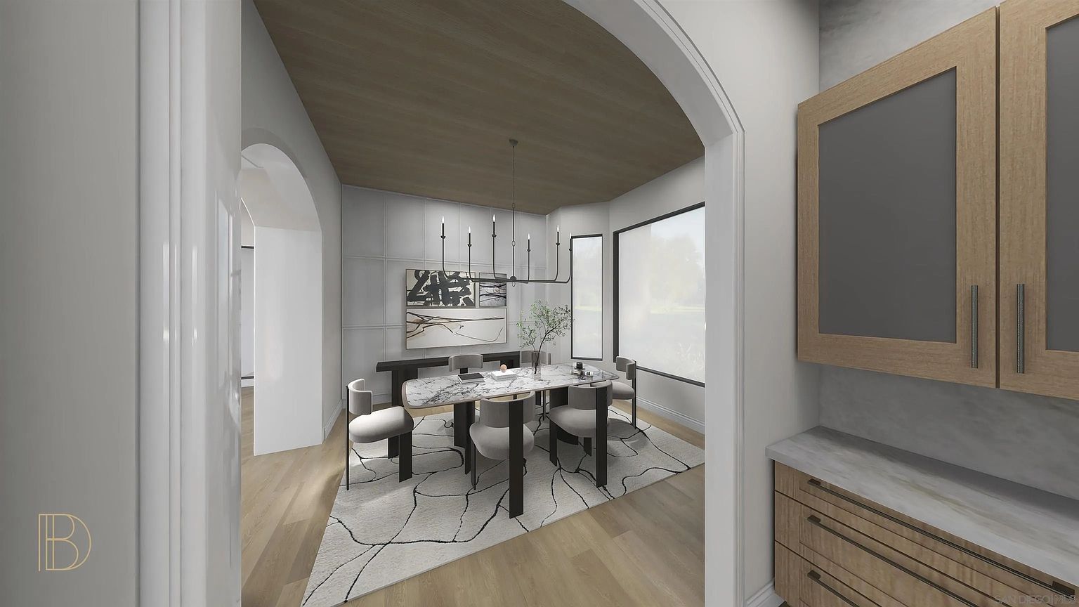 This is an interior shot of a dining room featuring a modern aesthetic. The room includes a marble-topped dining table surrounded by upholstered chairs, a contemporary chandelier, and a large abstract artwork on the wall. The space is well-lit with natural light from a nearby window, and a patterned rug adds visual interest to the wooden floor.