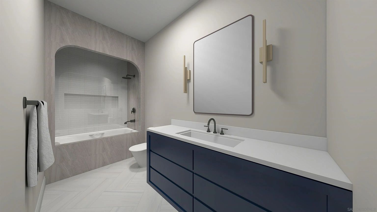 This is a primary bathroom featuring a modern vanity with a navy blue base and a white countertop, complemented by a large rectangular mirror and sconce lighting. The bathtub and shower area are enclosed with a unique arched design and light gray tiling, while the floor features a herringbone pattern. The overall impression is clean, contemporary, and luxurious.