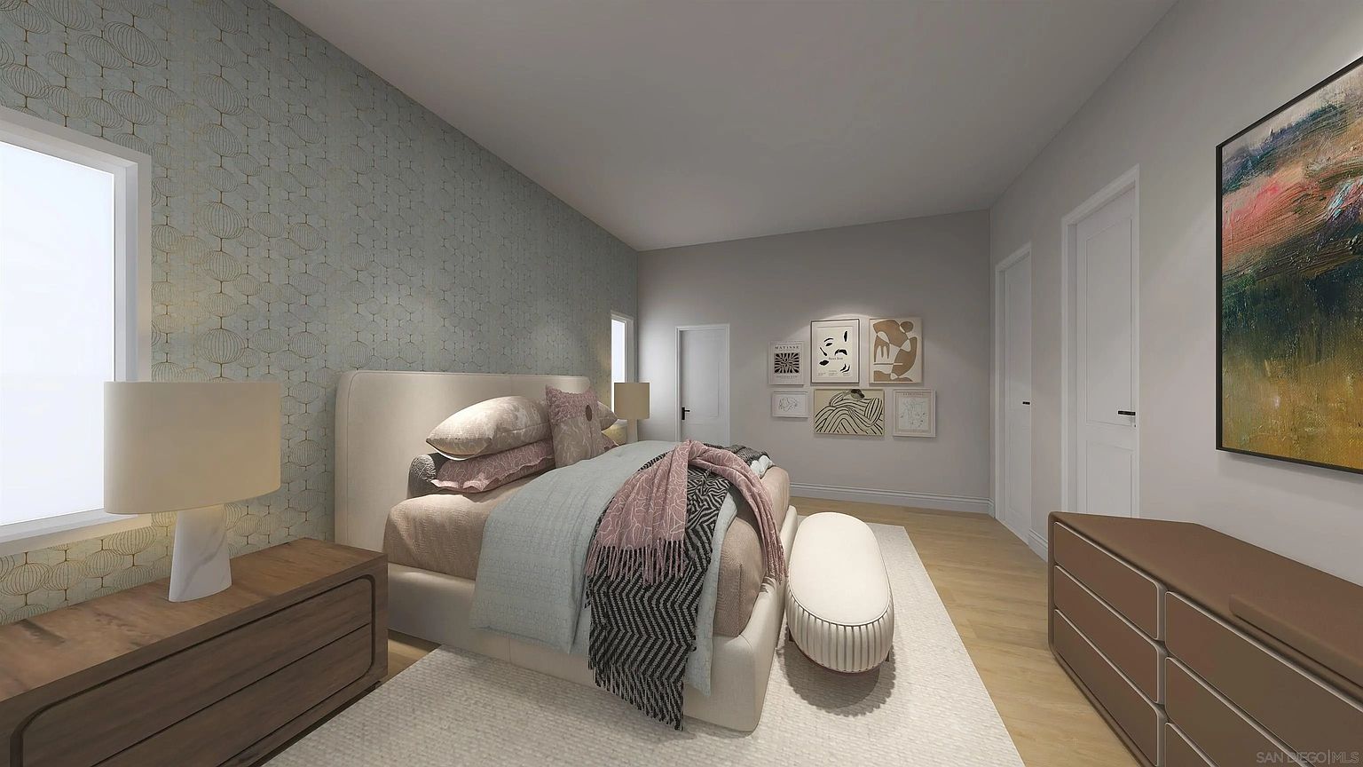 This is a primary bedroom featuring a large bed with neutral-toned bedding and decorative pillows. The room has a serene and stylish ambiance, enhanced by the patterned wallpaper, artwork, and a coordinating dresser. Natural light streams in through a window, creating a bright and inviting space.