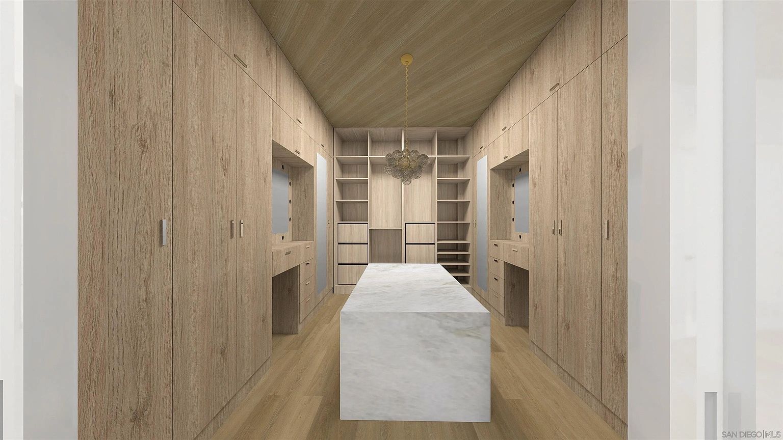This is a well-organized walk-in closet featuring light wood cabinetry and shelving on both sides, providing ample storage space. A central island with a marble countertop offers a surface for folding or displaying items. A decorative chandelier hangs from the wood-paneled ceiling, adding a touch of elegance to the space.