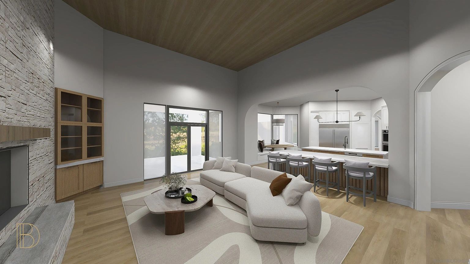 This is an interior shot of a modern living room that seamlessly transitions into a kitchen area. The living room features a large sectional sofa, a unique coffee table, and a stylish area rug. The kitchen boasts a breakfast bar with seating and stainless steel appliances, creating an open and inviting space perfect for entertaining.