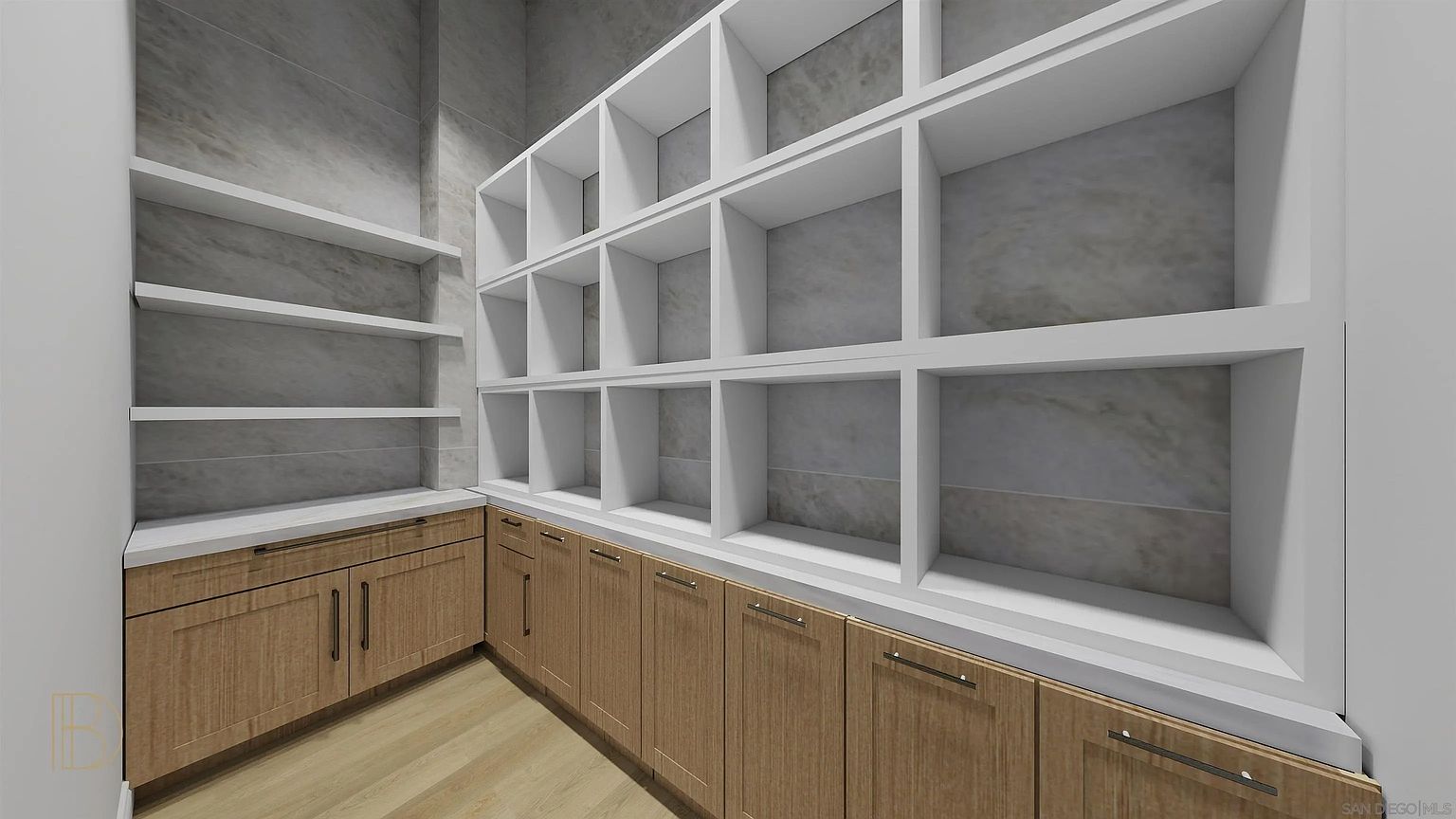 This is a well-organized pantry featuring wooden cabinets with sleek hardware and a white countertop. Above the counter, there are multiple rows of white shelving, creating ample storage space. The walls are a neutral gray, and the flooring appears to be light wood, contributing to a clean and modern aesthetic.