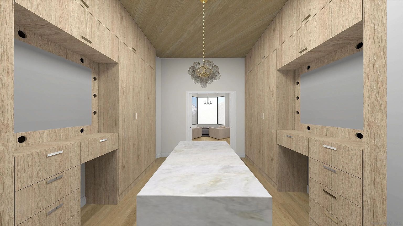 This is a well-organized walk-in closet featuring custom wooden cabinetry and a central island with a marble countertop. The closet includes built-in vanities with mirrors and ample storage space. A decorative chandelier hangs from the ceiling, adding a touch of elegance to the space.