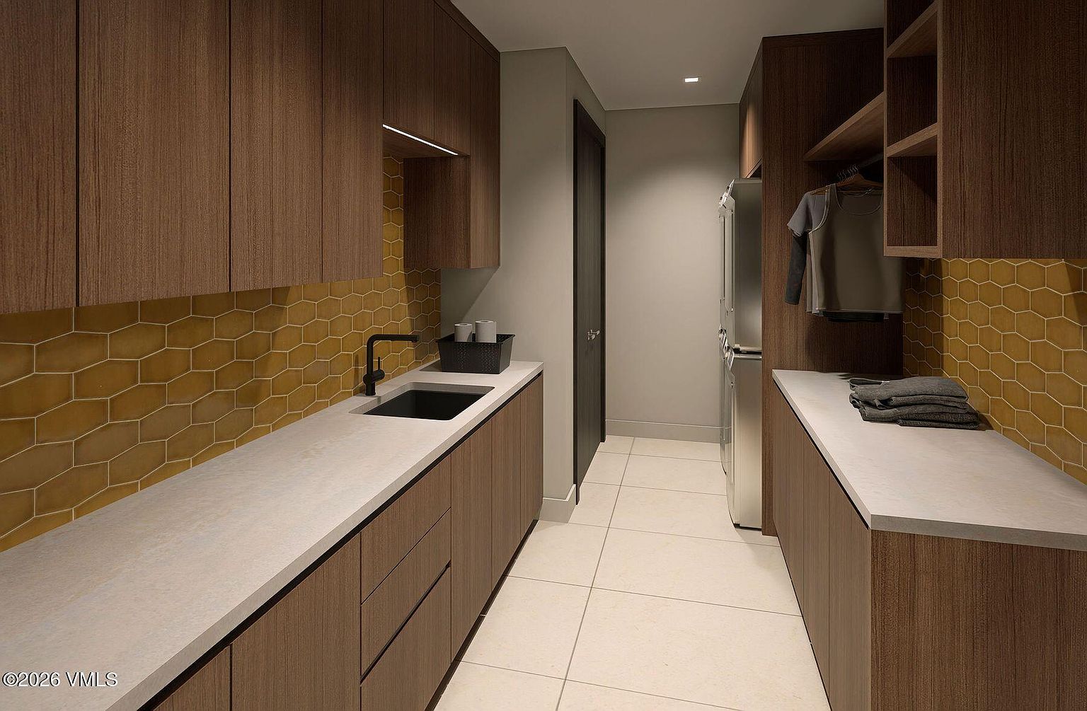 This modern laundry room features sleek, wood-toned cabinetry and a light-colored countertop with an integrated sink. A striking mustard-yellow hexagonal tile backsplash adds a vibrant pop of color, while the space is completed by light-colored floor tiles and a dedicated hanging area for garments. The perspective is a straight-on view looking down the narrow corridor, highlighting the efficient layout and contemporary design.