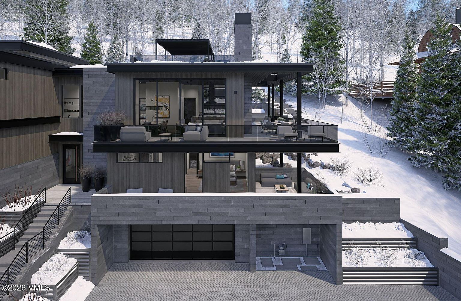 This modern mountain residence features a multi-level design with a striking combination of dark wood siding and grey stone masonry. The home includes expansive balconies on multiple levels, large glass sliding doors, and a built-in garage, all set against a snowy, forested hillside. The architectural style is contemporary and sleek, emphasizing indoor-outdoor living with a prominent stone chimney rising through the structure.