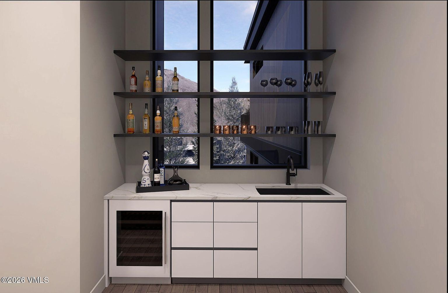 This modern wet bar features sleek white cabinetry, a stone countertop, and a built-in wine refrigerator. Three dark, minimalist floating shelves are mounted against a large window that provides a scenic view of a snowy, mountainous landscape. The space is finished with a dark faucet and sink, creating a sophisticated and contemporary aesthetic.