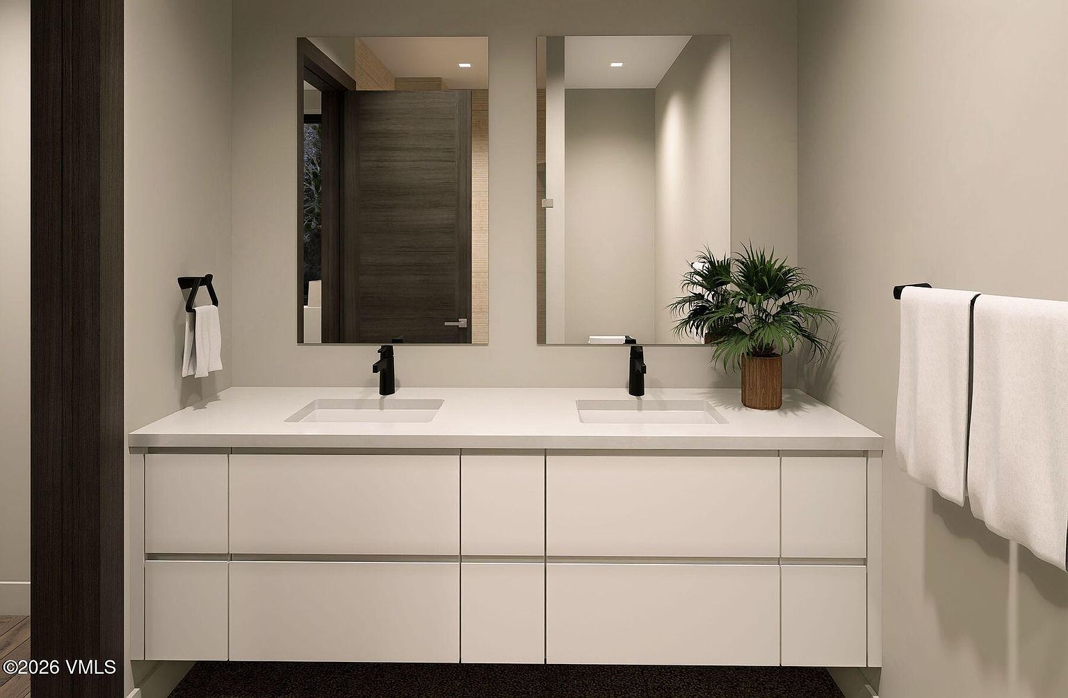 This modern double-vanity bathroom features a sleek, minimalist design with a long white countertop and integrated dual sinks. Two rectangular mirrors are mounted above the vanity, complemented by matte black fixtures and a potted plant that adds a touch of greenery. The space is finished with clean, neutral-toned walls and a towel rack holding white linens, creating a bright and contemporary atmosphere.