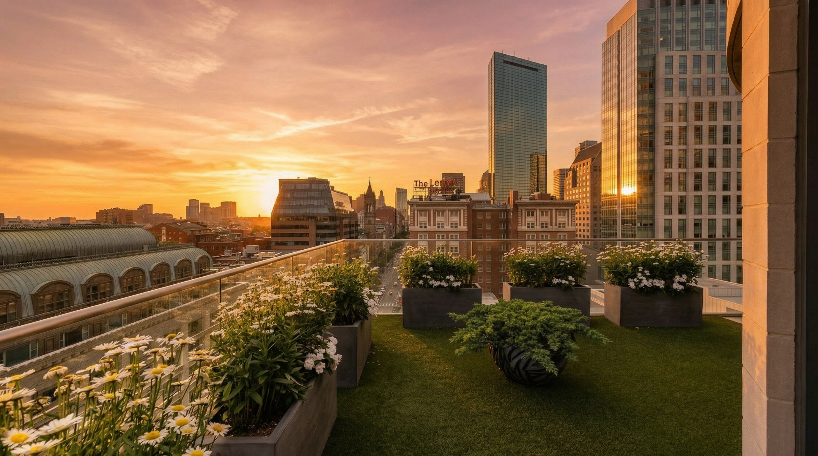 This breathtaking private balcony offers stunning sunset views over the urban skyline, featuring lush potted planters with white flowers and artificial turf flooring. The space is modern and inviting, seamlessly integrating nature with a sophisticated high-rise city environment. It provides an ideal outdoor setting for relaxation and entertainment against the backdrop of iconic architectural landmarks.