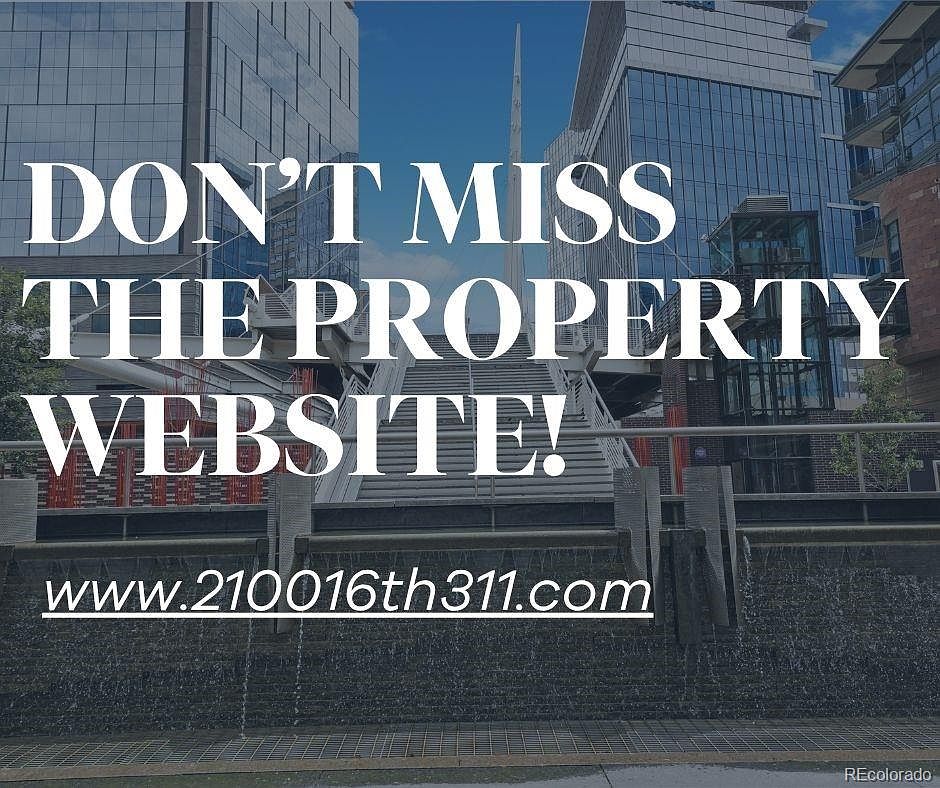 The image showcases a modern building exterior with a prominent pedestrian bridge and water feature in the foreground. The architecture features glass and steel, creating a contemporary aesthetic. The text overlay promotes a property website, suggesting this is a marketing image for a real estate listing.