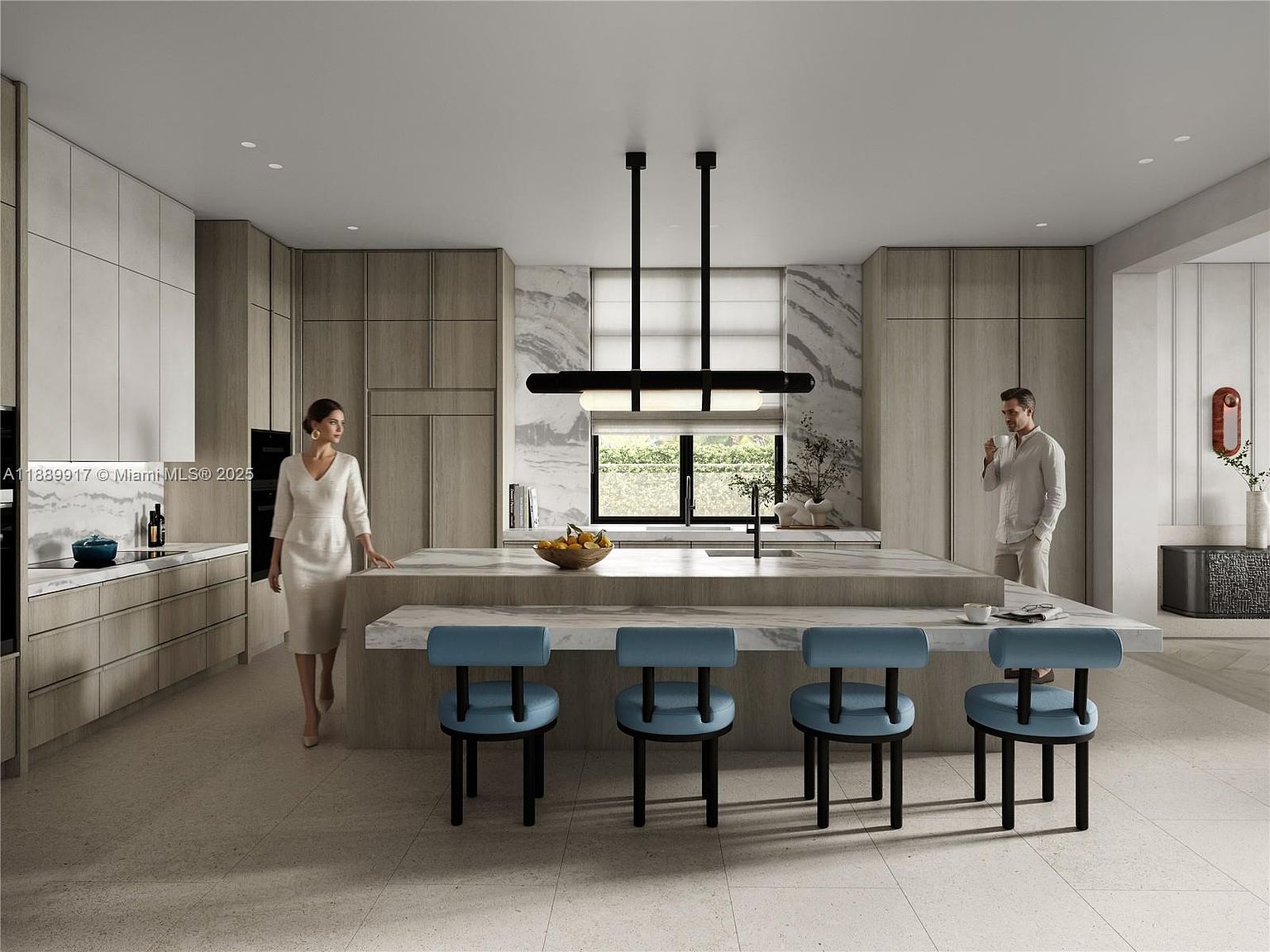 This is a modern kitchen with a large island featuring marble countertops and seating for four. The kitchen includes sleek, light wood cabinetry and a contemporary black pendant light fixture. The space is well-lit with natural light coming through a window above the sink, and two people are present in the scene, adding a sense of scale and lifestyle.