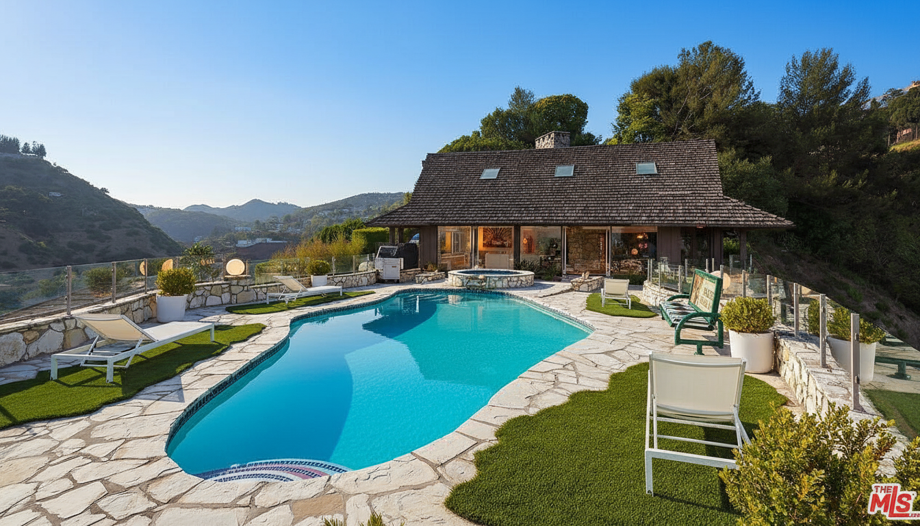 This exterior shot showcases a beautiful kidney-shaped pool and spa area. The pool is surrounded by stone paving and artificial grass, offering a luxurious and low-maintenance outdoor space. The property benefits from views of the surrounding hills, adding to its appeal.