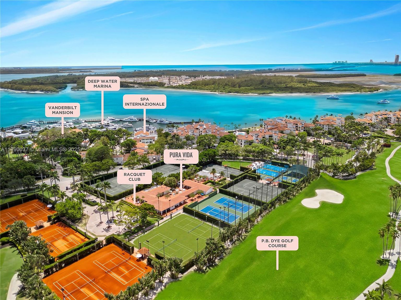 This aerial view showcases a luxurious waterfront property featuring a golf course, tennis courts, and a marina. The architecture includes Mediterranean-style villas with red-tiled roofs, surrounded by lush landscaping and palm trees. The scene conveys a sense of exclusivity and high-end living.