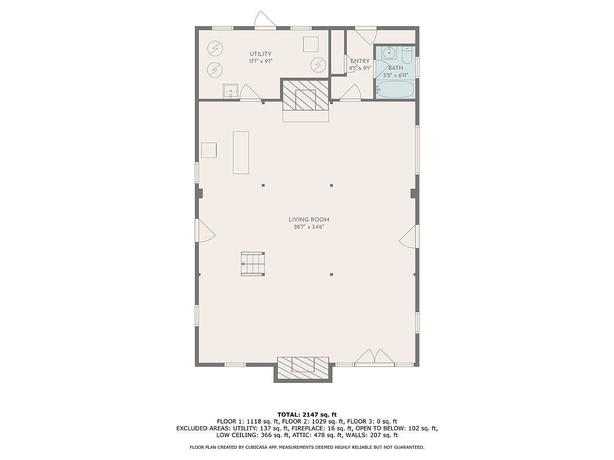 This image is a 2D floor plan diagram illustrating the layout of a single level. It features a large central living room, a utility room, an entry area, and a bathroom. The diagram includes specific room dimensions and total square footage calculations for the property.