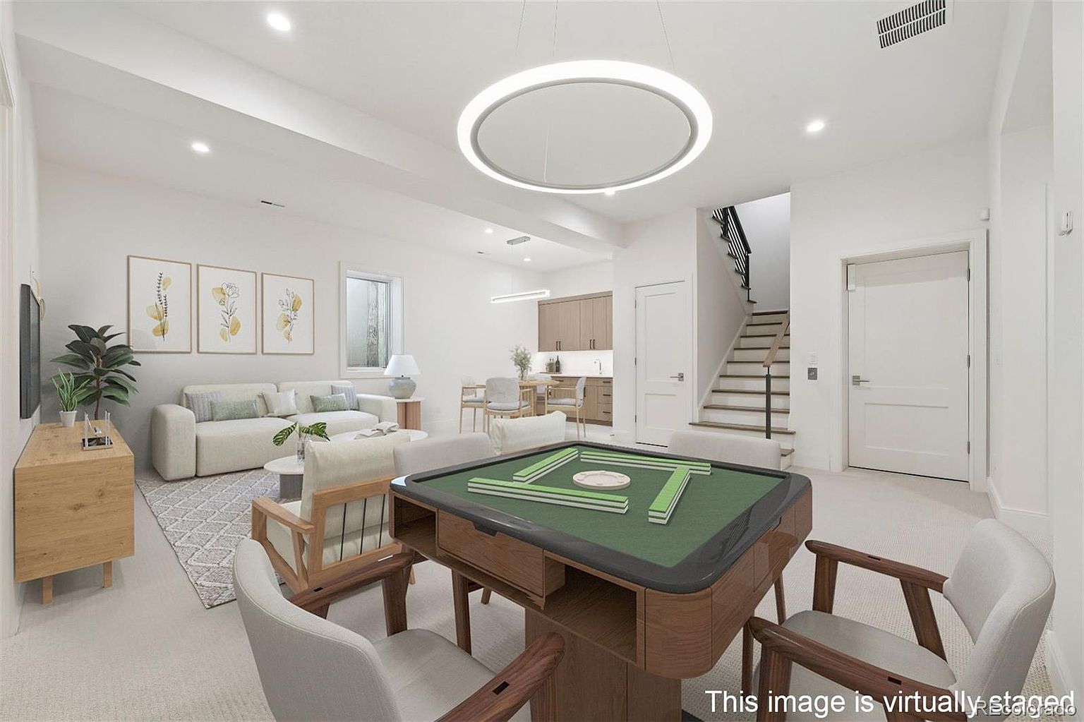 This is a bright and airy living room featuring a modern design with clean lines and neutral colors. The room includes a comfortable sofa, artwork, and a unique circular light fixture. A mahjong table with chairs is prominently featured, suggesting a space for entertainment and relaxation.