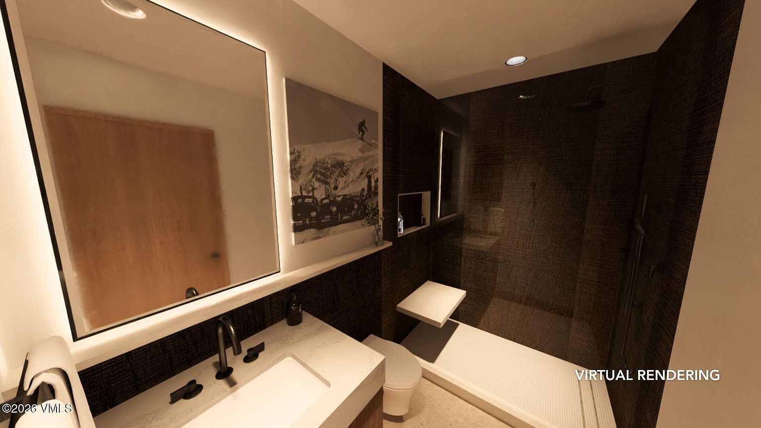 This is a modern bathroom featuring a sleek vanity with a white countertop and dark fixtures. A large, illuminated mirror hangs above the sink, and a black and white photograph adds a touch of sophistication. The shower area is enclosed with dark textured tiles and includes a built-in bench, creating a spa-like atmosphere.