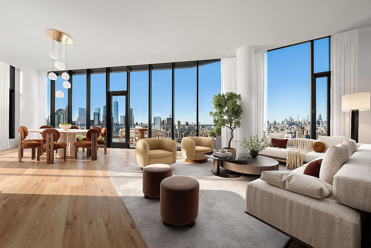 This expansive, sun-drenched living and dining area features floor-to-ceiling windows that offer breathtaking panoramic views of the New York City skyline. The interior boasts a sophisticated, modern aesthetic with light hardwood flooring, a neutral color palette, and high-end contemporary furnishings, including a plush sectional sofa and sculptural accent chairs. The open-concept layout creates a seamless flow between the dining space and the lounge area, emphasizing luxury, space, and natural light.
