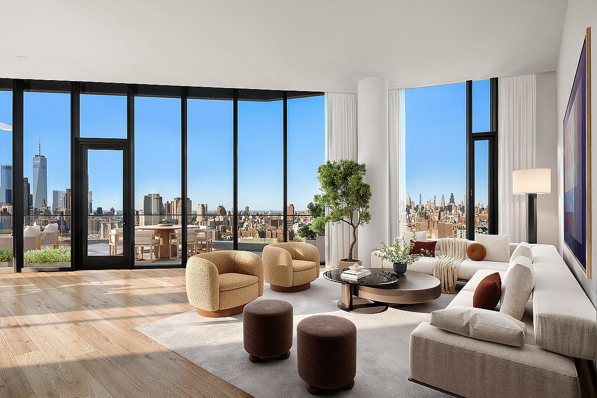 This sophisticated, high-end living room features floor-to-ceiling windows that offer a breathtaking panoramic view of the New York City skyline, including One World Trade Center. The space is furnished with a plush, neutral-toned sectional sofa, two textured accent chairs, and a sleek, circular coffee table, all arranged on a soft area rug. The interior design is modern and minimalist, emphasizing natural light and an open-concept layout that seamlessly connects to an outdoor terrace.