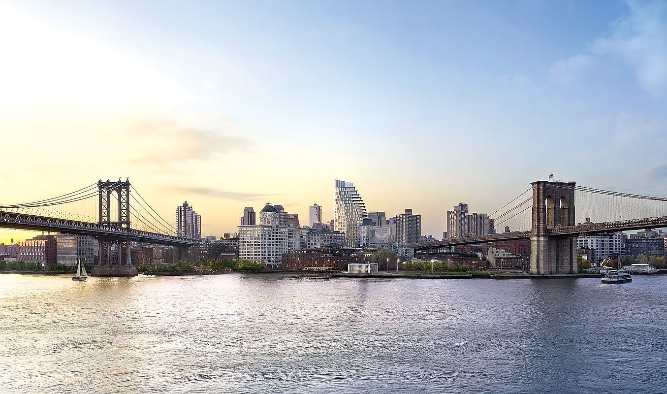 This cinematic wide-angle shot captures the iconic New York City skyline at dusk, featuring the Manhattan Bridge on the left and the Brooklyn Bridge on the right. The East River flows prominently in the foreground, reflecting the soft golden light of the setting sun. The composition highlights the juxtaposition of historic bridge architecture against the modern high-rise buildings of the city, creating a grand and aspirational urban atmosphere.