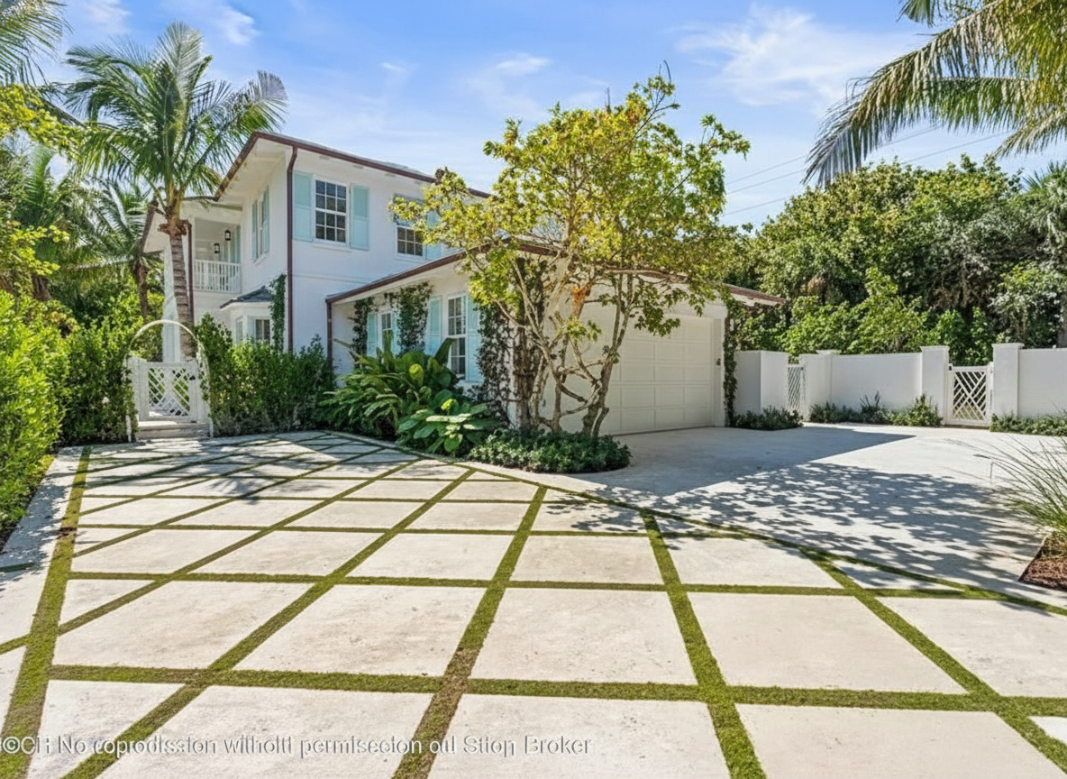 The image showcases the front exterior of a two-story home. The property features a well-manicured lawn, palm trees, and a patterned driveway with grass or moss interweaving. Key elements create an inviting curb appeal, suitable for a real estate listing.