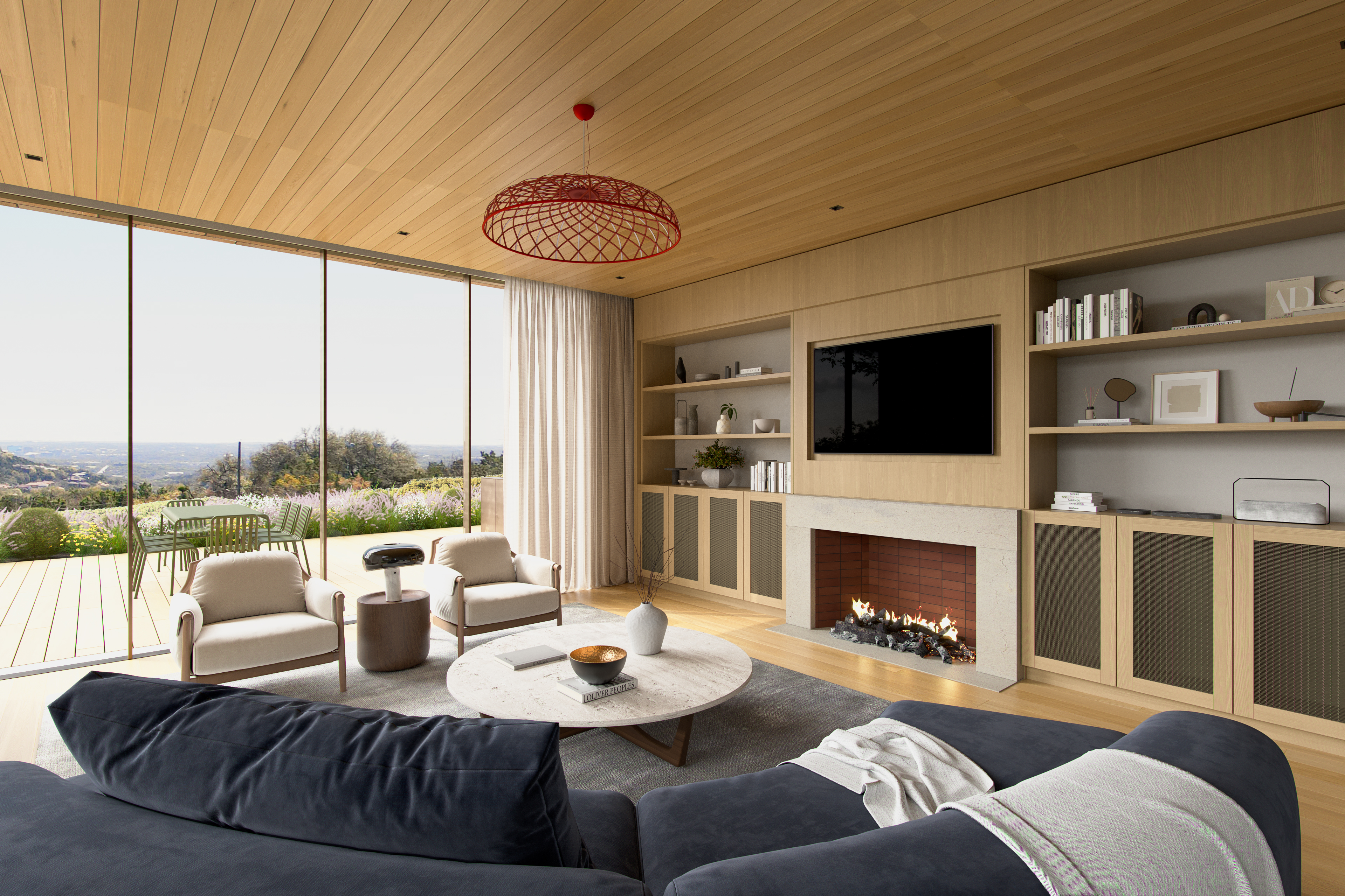 This sophisticated, contemporary living room features floor-to-ceiling windows providing expansive, scenic outdoor views. The space is anchored by a stone-faced fireplace with custom light wood built-in shelving, complemented by a plush navy sectional and a modern light wood ceiling. A bright red architectural pendant fixture adds a striking artistic element, creating a warm, luxury-focused atmosphere.