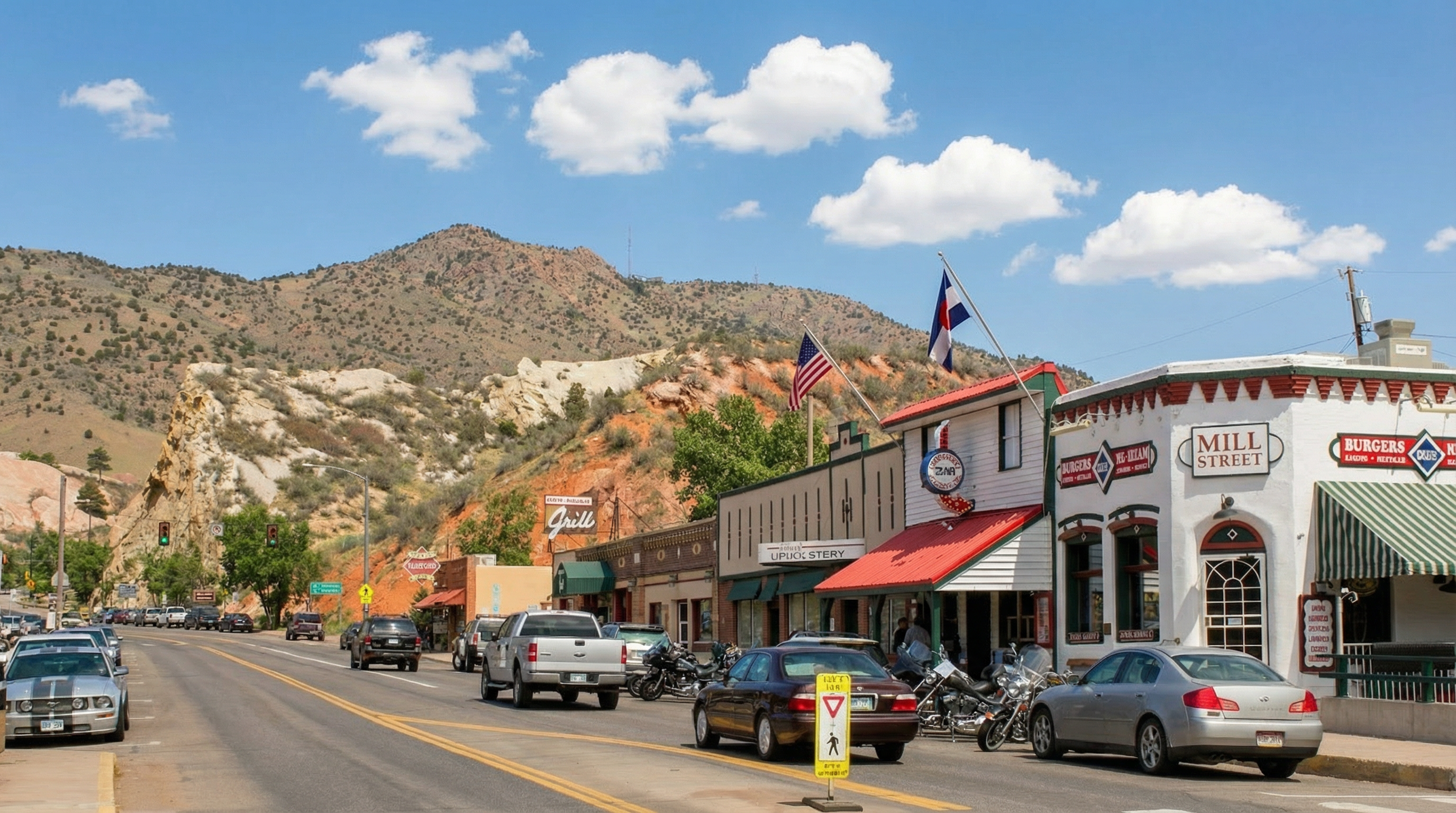 The image showcases a vibrant street view of a small town's main street, capturing a diverse collection of commercial buildings with unique architectural details. Several businesses, including restaurants and an upholstery shop, line the street, each contributing to the town's character. Cars and motorcycles populate the street, suggesting a lively and accessible location.
