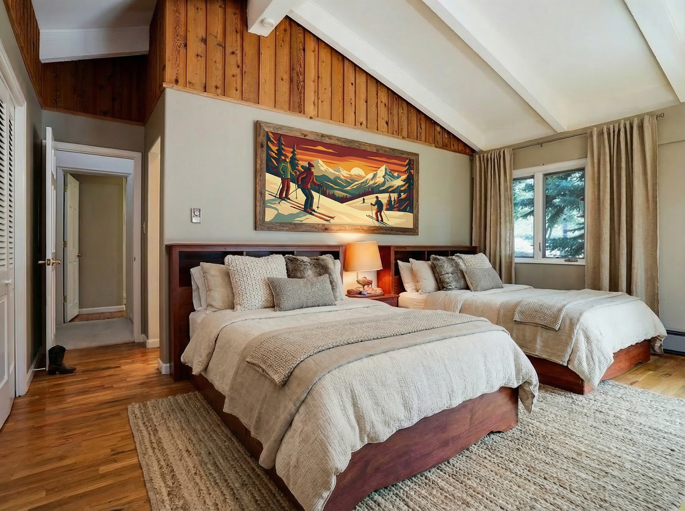 This is a welcoming guest bedroom featuring two twin beds with wooden frames and neutral-toned bedding. The room is decorated with a rustic-style artwork above the headboards and has a cozy rug on the hardwood floor. The space is bathed in natural light coming through a window covered with beige curtains, adding to the inviting atmosphere.