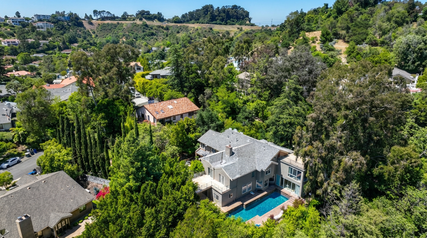 This aerial shot showcases a luxurious home nestled among lush greenery. The property features a swimming pool, a spacious deck, and a well-maintained exterior. The surrounding landscape provides privacy and a sense of tranquility, making it an appealing retreat.