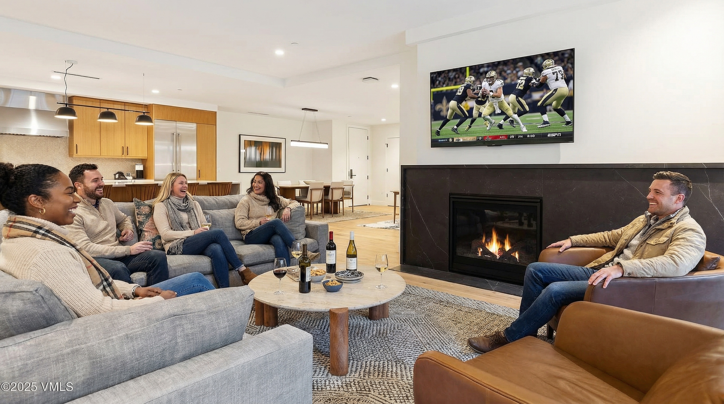 The image showcases a modern living room, designed for relaxation and entertainment. A comfortable sectional sofa accommodates multiple individuals, while an armchair sits near a fireplace and TV, creating a cozy focal point. The room is well-lit and features contemporary furnishings, suggesting a stylish and inviting living space perfect for a family or entertaining.