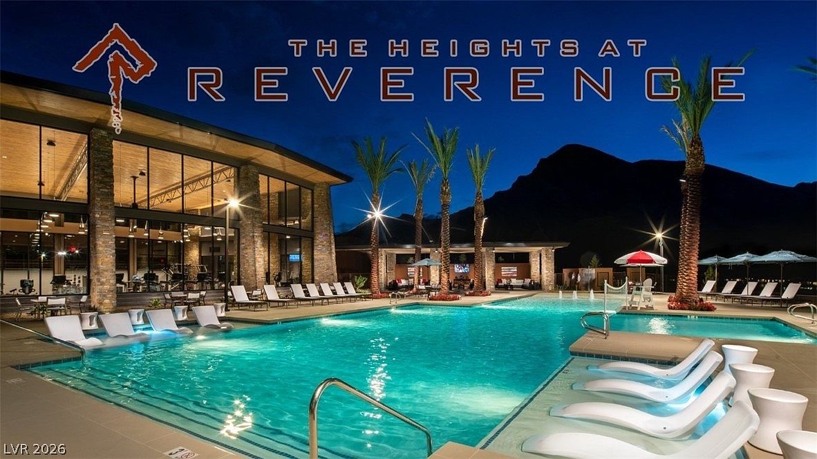 This image showcases a stunning, resort-style community pool area at The Heights at Reverence, captured at dusk for a sophisticated atmosphere. The scene features a spacious pool with integrated lounge chairs, a modern clubhouse with floor-to-ceiling glass walls, and scenic mountain views in the backdrop. This amenity-rich setting offers an upscale lifestyle appeal perfect for recreational relaxation and social gatherings.
