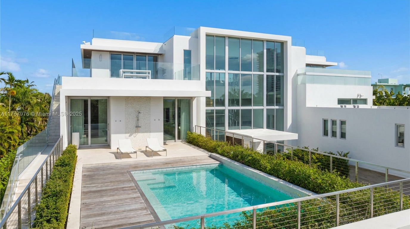 This image showcases the exterior of a modern home with a rectangular swimming pool. The pool area features a wooden deck and is surrounded by greenery, adding a touch of nature. The house has a contemporary design with large windows and white exterior, maximizing natural light and providing a sleek aesthetic.