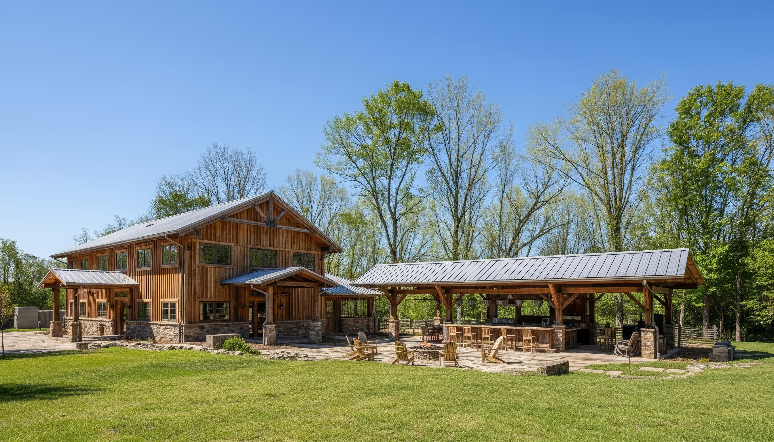 This exterior shot showcases a well-maintained yard with a custom-built wooden house and an outdoor entertainment area. The house features a gable roof and a stone foundation, with complementary stone pathways and landscaping details throughout the yard. The outdoor entertainment space includes a covered bar area and a fire pit, perfect for gatherings.
