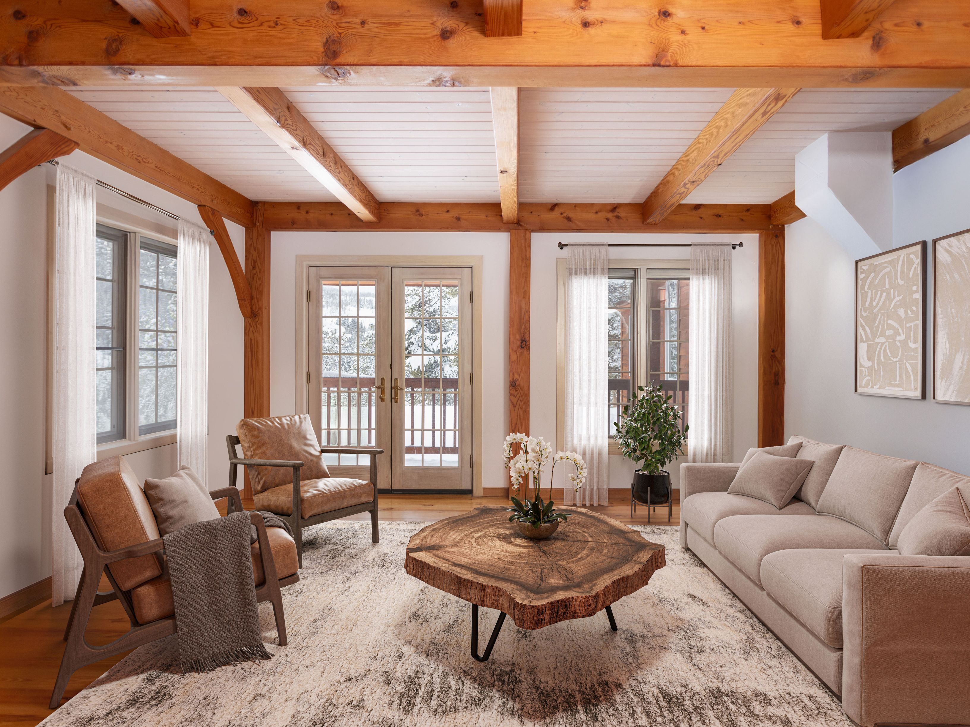 This inviting living room features a rustic-modern aesthetic, highlighted by exposed timber ceiling beams and a striking live-edge wood coffee table. The space is furnished with a neutral-toned sofa and two leather armchairs, all arranged on a textured area rug that anchors the room. Large windows and glass doors provide ample natural light and a scenic view of a snowy landscape, creating a warm and cozy atmosphere.