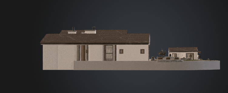 This image depicts a detailed scale architectural model of a single-story residential property. It showcases a side profile of the home with a clear view of the exterior facade, roofline, and an adjacent patio area with small trees and seating. The composition provides a comprehensive look at the house's overall footprint and outdoor layout.