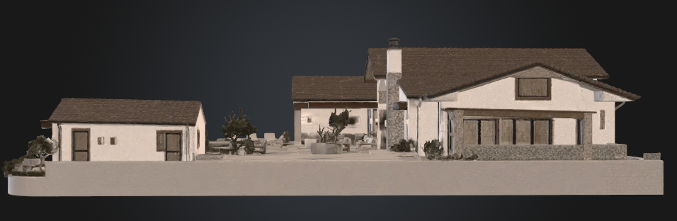 This 3D model perspective shows the rear exterior of a single-story home, featuring a spacious patio area situated between a smaller detached outbuilding and the main residence. The house showcases a traditional architectural style with a brown shingled roof, light-colored stucco walls, and stone masonry accents, creating a warm and inviting backyard environment. The layout emphasizes an integrated indoor-outdoor living space, perfect for entertainment and relaxation.