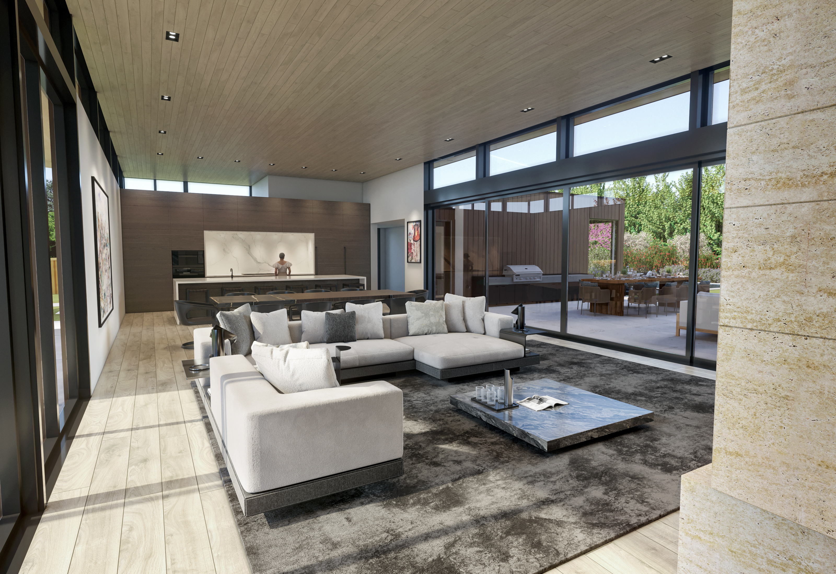 This spacious, modern open-concept living room area flows seamlessly into a sleek kitchen and outdoor dining space. The room features high-end contemporary furniture, including a large sectional sofa and a dark marble coffee table, all set upon a textured area rug. With expansive floor-to-ceiling glass sliding doors, the space is flooded with natural light and offers a perfect indoor-outdoor living experience.