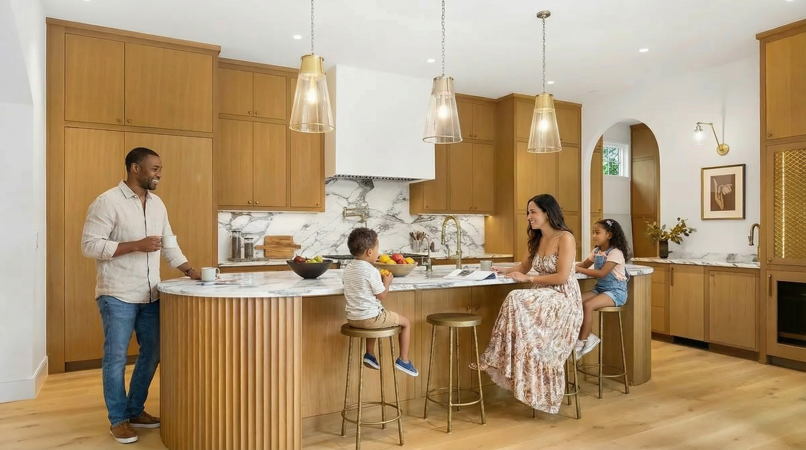 This is a bright and modern kitchen featuring warm wood cabinetry, marble countertops and backsplash, and gold hardware. The kitchen island with a seating area is perfect for family gatherings. Pendant lights illuminate the island, and there is plenty of storage space within the various cabinets.
