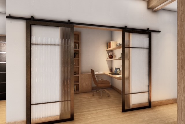 This interior shot showcases a stylish home office space. The office features a built-in desk, shelving, and a set of striking glass sliding doors that add privacy and visual interest. The room has a light and airy feel, with wooden floors enhancing the overall aesthetics.