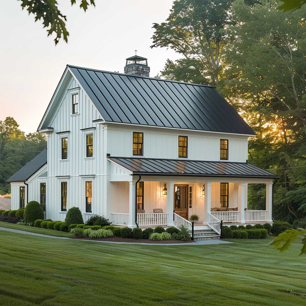 This charming modern farmhouse features crisp white vertical board-and-batten siding paired with a sleek black standing-seam metal roof. The home is highlighted by a spacious, wrap-around covered porch with elegant white railings, set against a backdrop of mature trees and a manicured green lawn. The architectural style blends traditional country aesthetics with contemporary clean lines, creating an inviting and well-maintained curb appeal.
