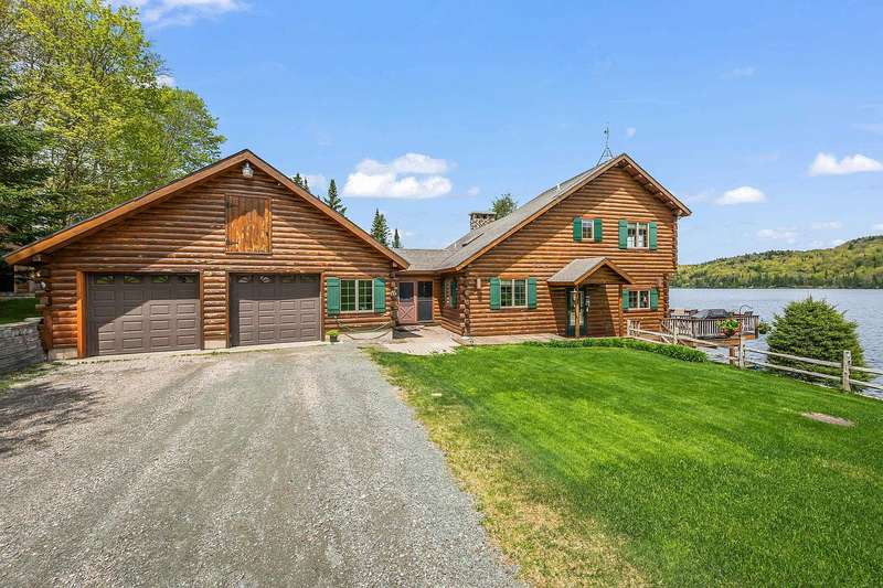 A Custom Log Retreat on Three Hundred Feet of Diamond Pond